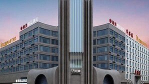 Un edificio moderno con un elemento vertical central y dos alas.