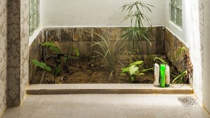 A corner shower with a built-in planter containing plants. - Two independents BR in a pristine area in Hoi An (Thành phố Hội An)