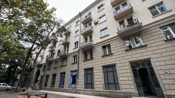 A multi-story building with balconies, a ground-level entrance, and a visible sign with the number 179. - Apartment in historic Tbilisi (Tbilisi)