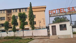 A hotel with a signboard reading "HOTEL SARIKA" and "A/C & NON-MARRIAGE LAWNS".