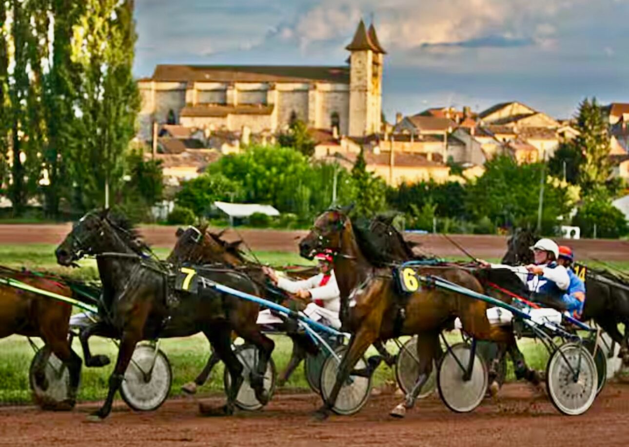 A horse race with jockeys in traditional attire on horseback.