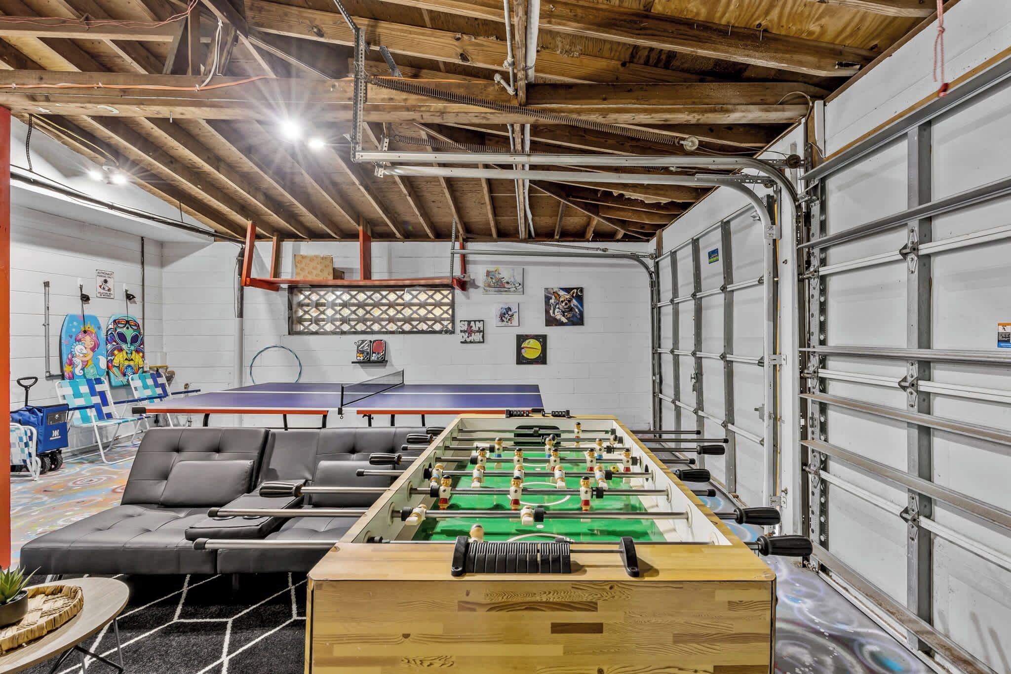 Game room with foosball and ping pong tables for family-friendly fun.