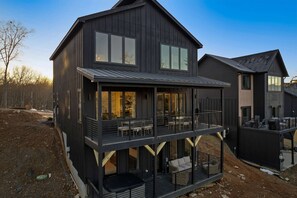 Enjoy the view from the spacious balcony with outdoor seating.