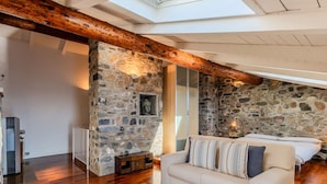 A cozy room with a stone wall, wooden beams, a sofa, and a billiards table. - Lovely apartment for 6 people with WIFI and TV (San Siro)