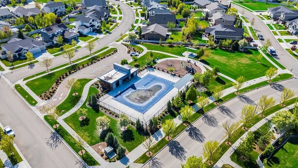 An aerial view of a residential area with a central building featuring a large parking lot and a playground. - A Motown-Inspired Vinyl Retreat (Meridian)