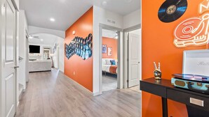 A modern interior with a hallway leading to a bedroom. - A Motown-Inspired Vinyl Retreat (Meridian)