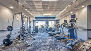 A gym with treadmills, elliptical machines, and weightlifting equipment. - Blue Water Resort #19 great studio on the beach! (Myrtle Beach)