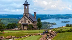 A stone church with a steeple, surrounded by a golf course and a lake. - L 7-8 Beautiful views, clean, cozy and close to SDC (Branson)