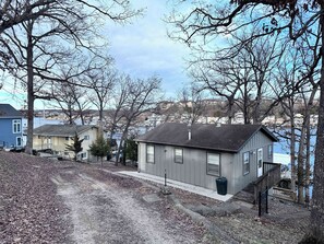 Situated on a sloped terrain, this two-story house offers a serene residential setting.