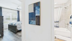A modern bathroom with a bathtub, shower, and toilet. - Near Sawgrass Grove in The Village of Newell (The Villages)