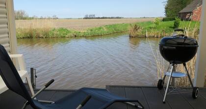 House on the canal near Greetsiel, rowing boat fishing directly from the jetty, pets allowed