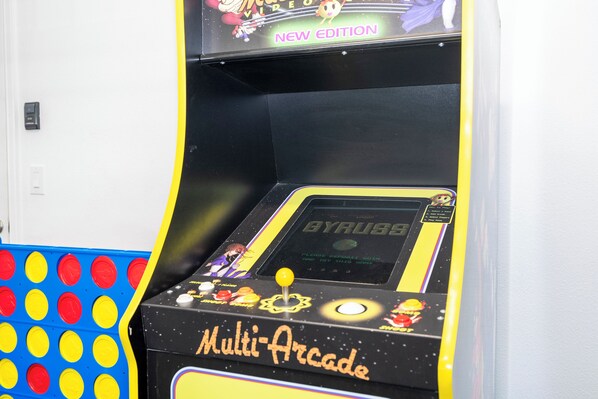 A multi-arcade game machine with a yellow and black color scheme, featuring various game titles and a joystick control panel.