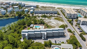 A coastal hotel with multiple buildings, a swimming pool, and a beach view. - The Mini Pearl 30A beach studio - Dog Friendly! (Santa Rosa Beach)