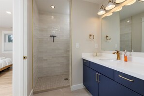 The private en suite bathroom for king bedroom 3 includes a tiled shower and vanity.