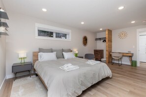 King bedroom 2 includes a desk, dresser, hanging storage, and a private en suite bathroom.
