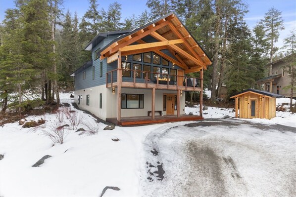 Your Girdwood retreat in winter, with a covered upper deck and private sauna beside the home