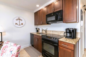 Enjoy cooking in this well-equipped kitchen with an oven, microwave, and coffee maker.