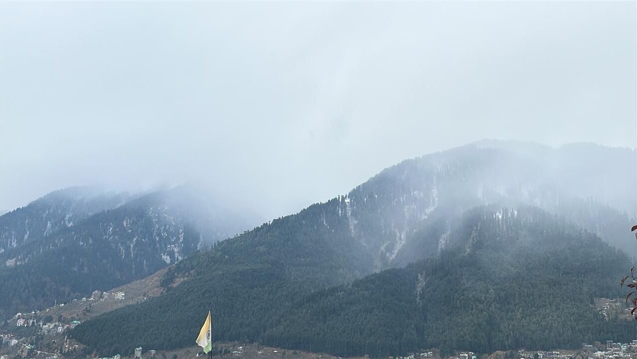 A mountainous landscape with a flag in the foreground.