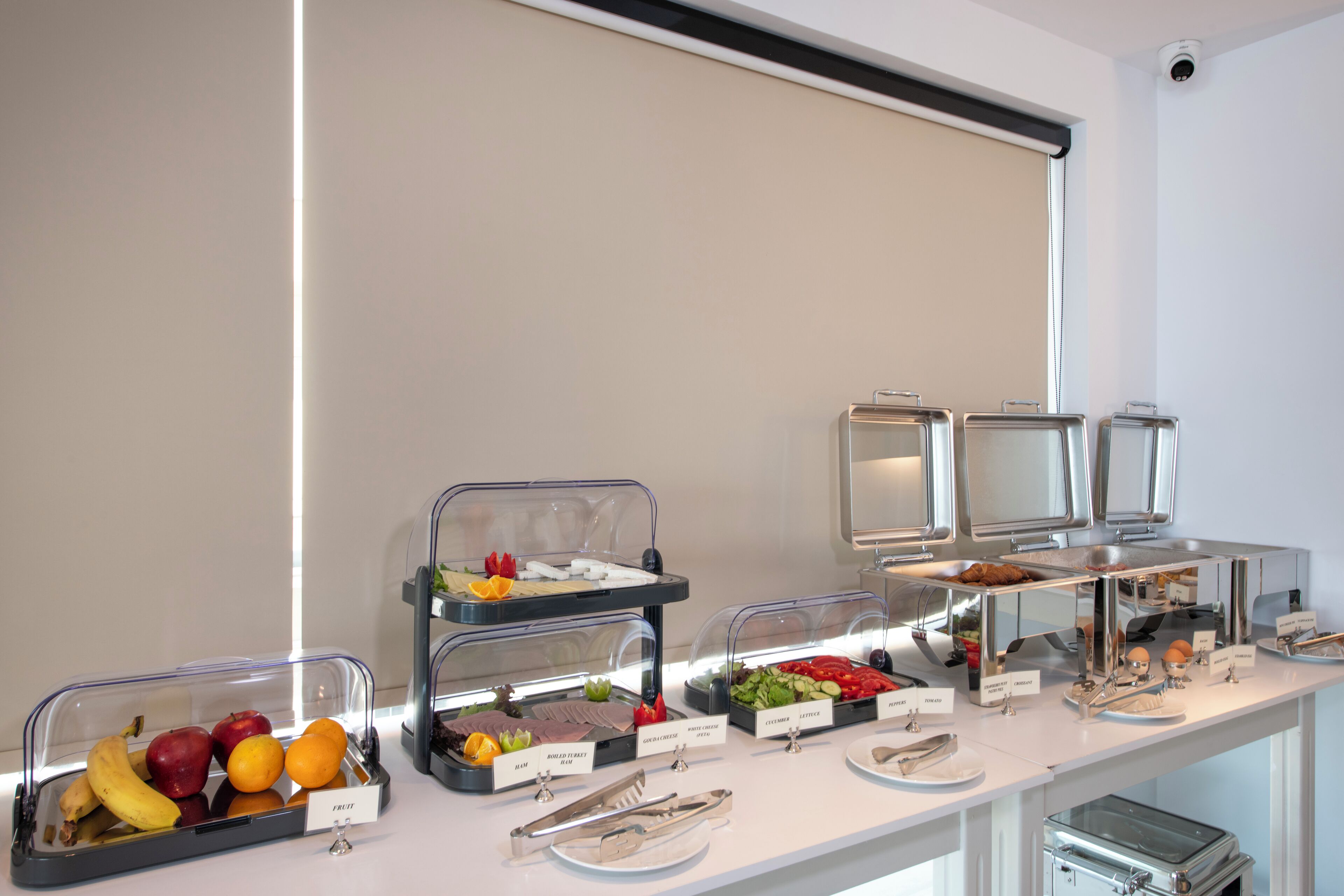 A buffet with various food items and utensils.