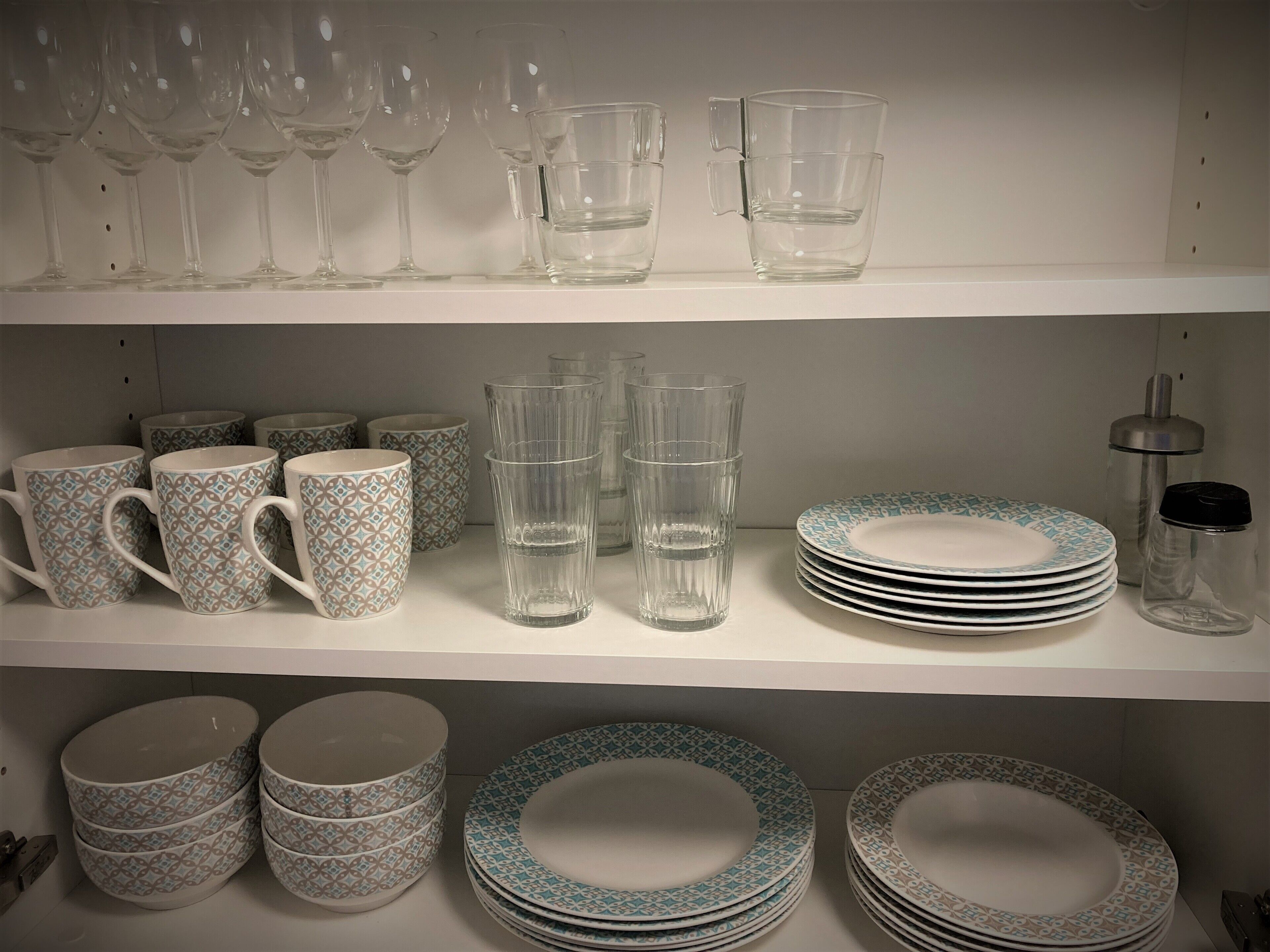 A display of glassware and plates on shelves.