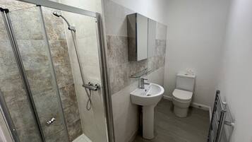 Shower, hair dryer, towels, soap