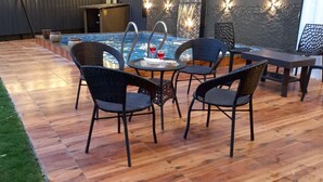 A poolside area with wicker chairs and a table, a small pool, and a wooden deck. - Villa MTDC registeredwithSwimming pool,Lift,Microwave,Washingmachine,Wifiparking (Lonavala)