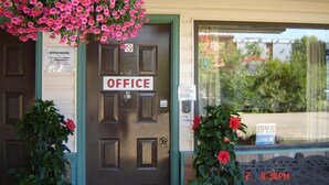 A door labeled "OFFICE" with a sign indicating office hours and a "NO ENTRY" sign. - HOO - DOO MOTEL (Drumheller)