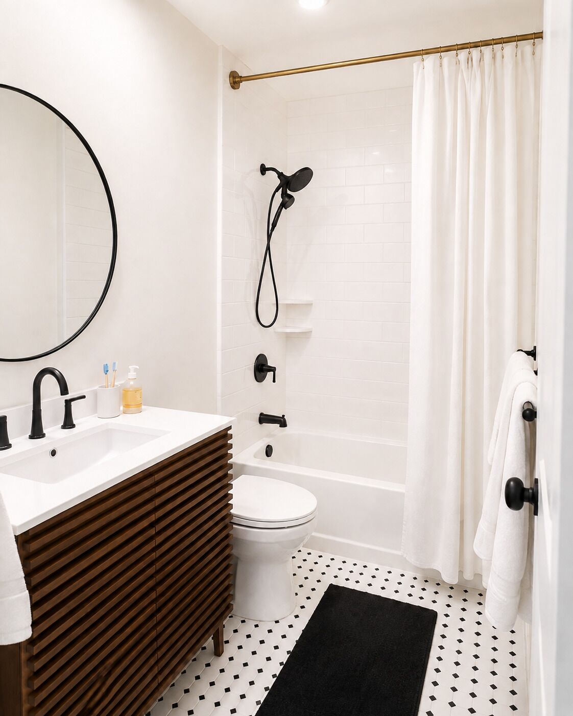 A modern bathroom with a sink, toilet, and shower.