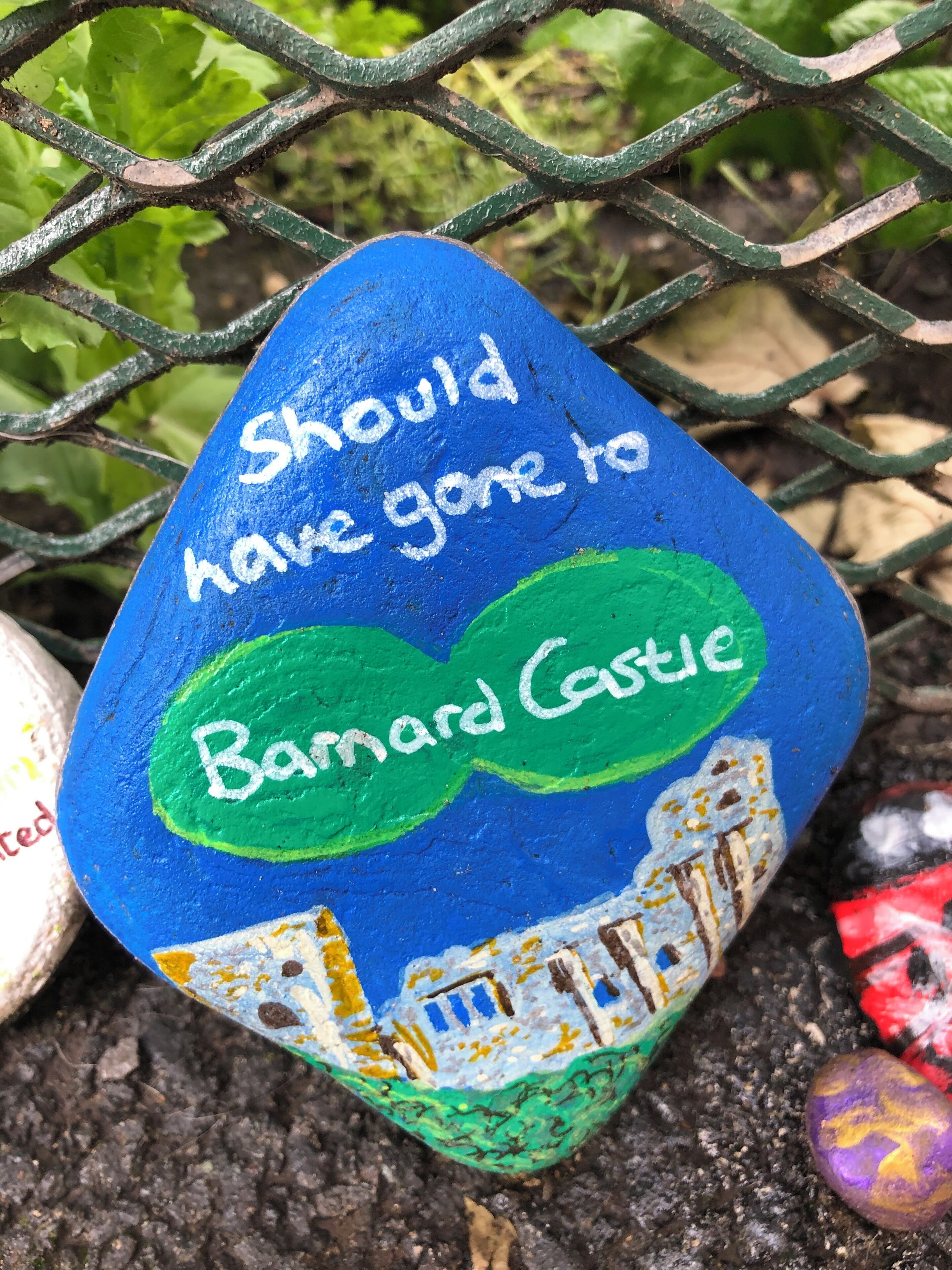 A painted rock with the text "Should have gone to Barnard Castle" and a castle illustration.