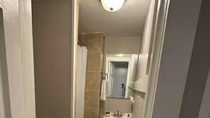 Un baño pequeño con inodoro, lavabo y ducha.