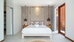 A modern bedroom with a large bed, wooden panel walls, and a decorative ceiling piece. - Elephant Villa 5 by Villa Finder (Ubud)