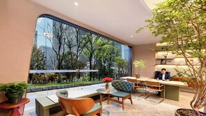 A modern interior with a large window, a dining area, and a bookshelf. - lanziguojijiudian (Chongqing)
