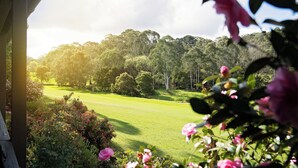 A view of a golf course with a forested hill in the background. - Mount Lofty Golf Course (Stirling)