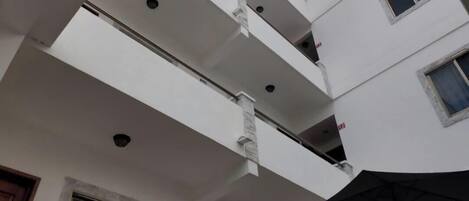 A multi-level building with balconies and a skylight.