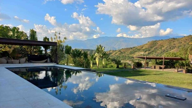Una piscina con vistas despejadas a montañas al fondo.