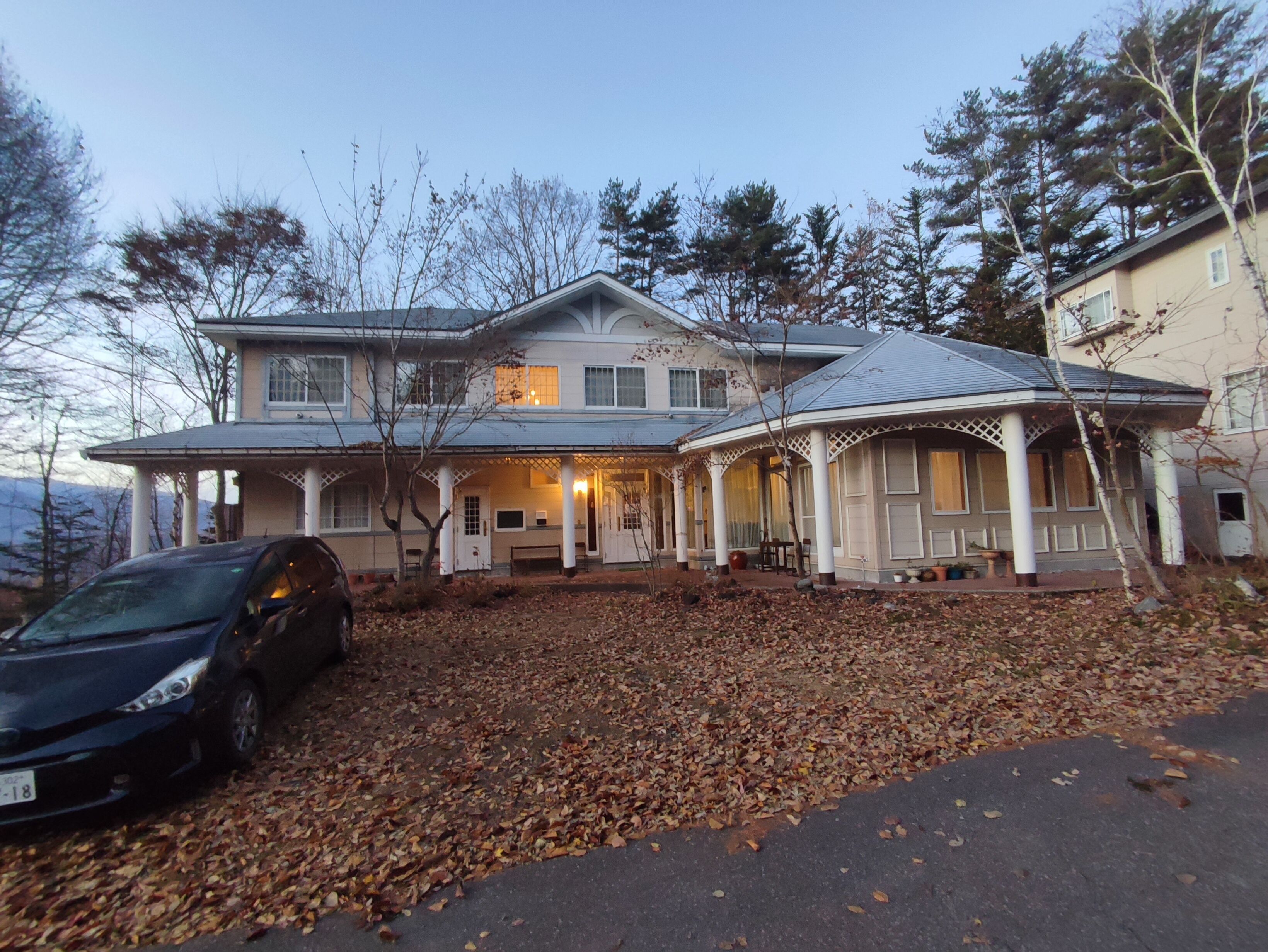 A large house with a covered porch and a garage.