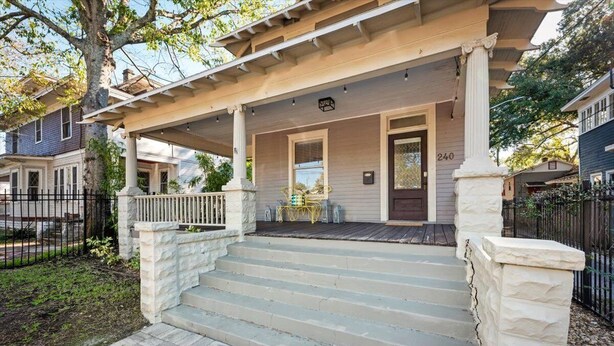 A two-story house with a covered porch, stone steps, and a mailbox. - 240- History Buff, Sleeps 10, Central Location to FUN, Pet & Family Friendly (Jacksonville)
