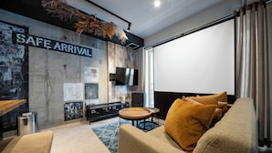 A modern living room with a sofa, a coffee table, and a TV screen. - TAKETO STAY KOTONI 102 (Sapporo)