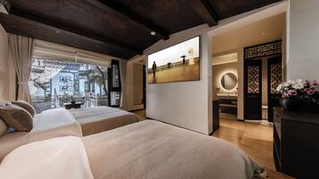 Habitación de hotel moderna con una cama grande, un escritorio y vistas a un paisaje urbano a través del ventanal.
