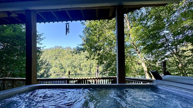 A hot tub with a view of a forested area. - Great Fall pricing! Magical Views & Peaceful Vibes; private dock, kayaks, firepit, office! (Newtown)