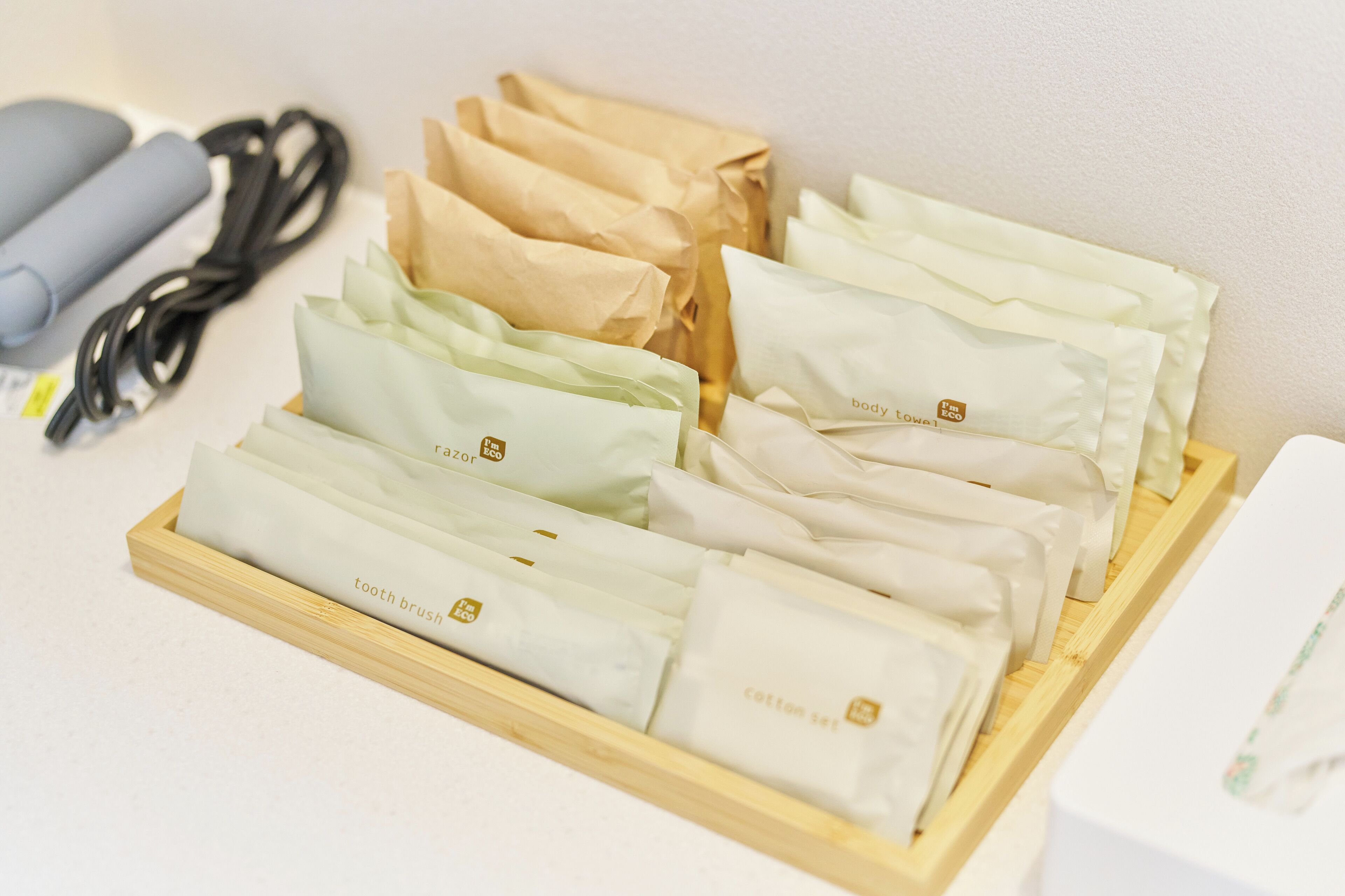 A tray of neatly arranged cotton swabs and toothpastes in various colors.