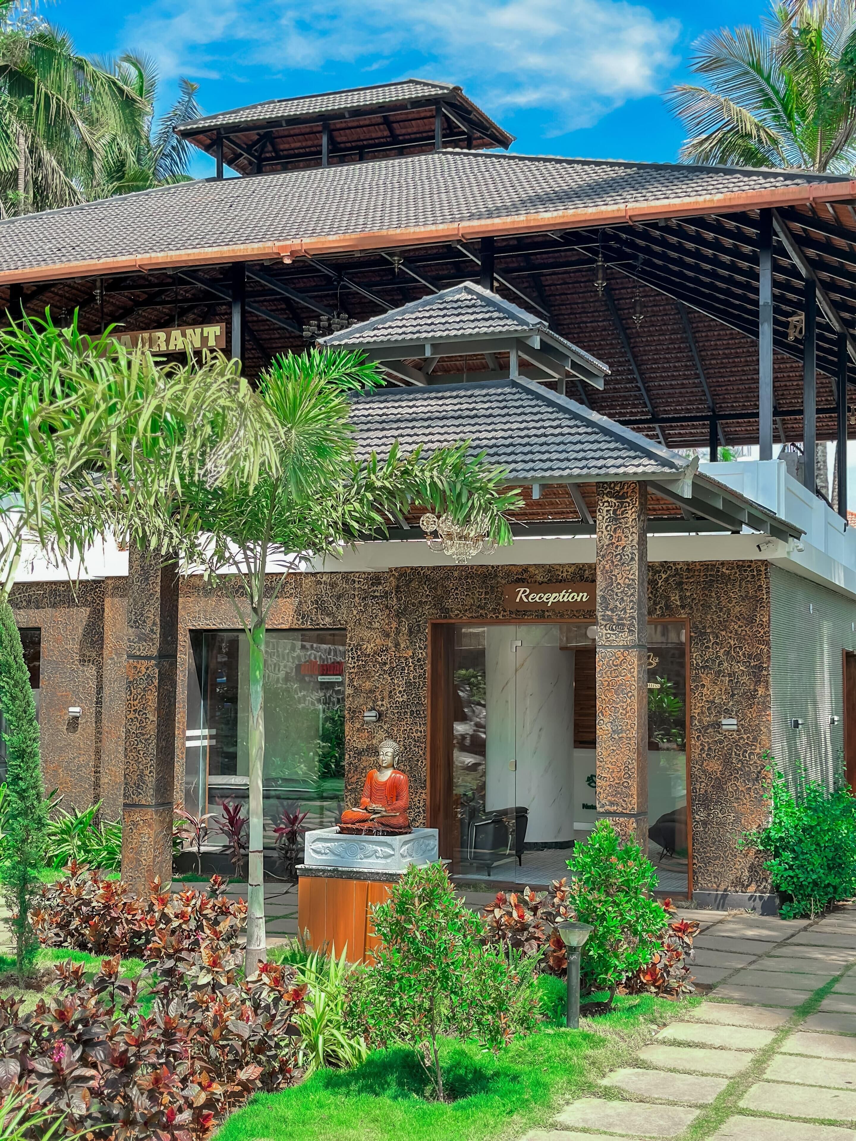 A building with a reception area, a Buddha statue, and a sign that reads "RECEPTION".