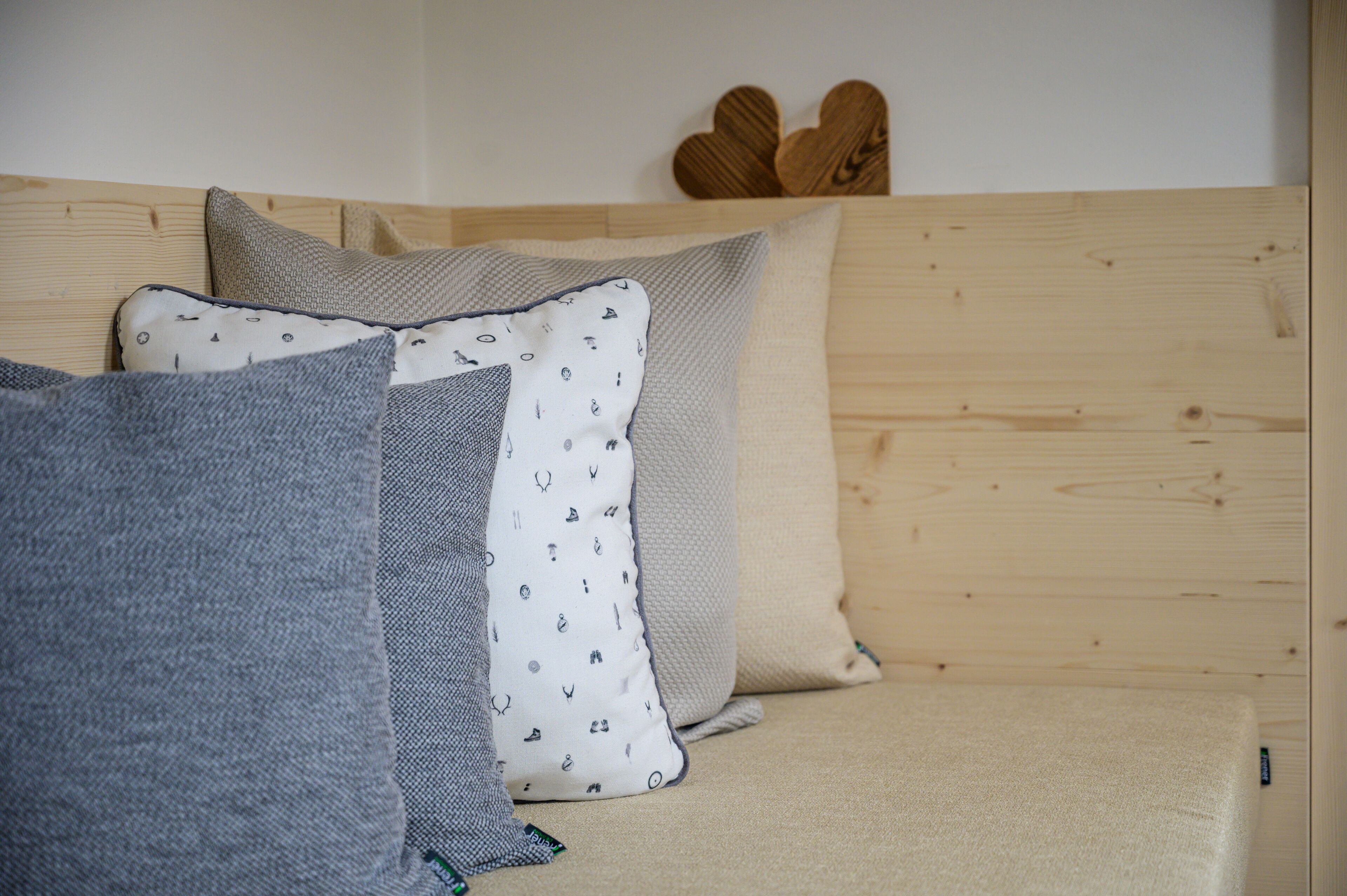 A bed with multiple pillows and a wooden headboard.