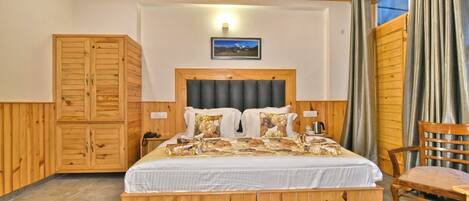 A wooden-paneled bedroom with a bed, a wardrobe, and a chair.