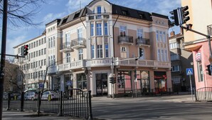 A multi-story building with a classic architectural style, featuring large windows and balconies. - Corner House (Lovech)