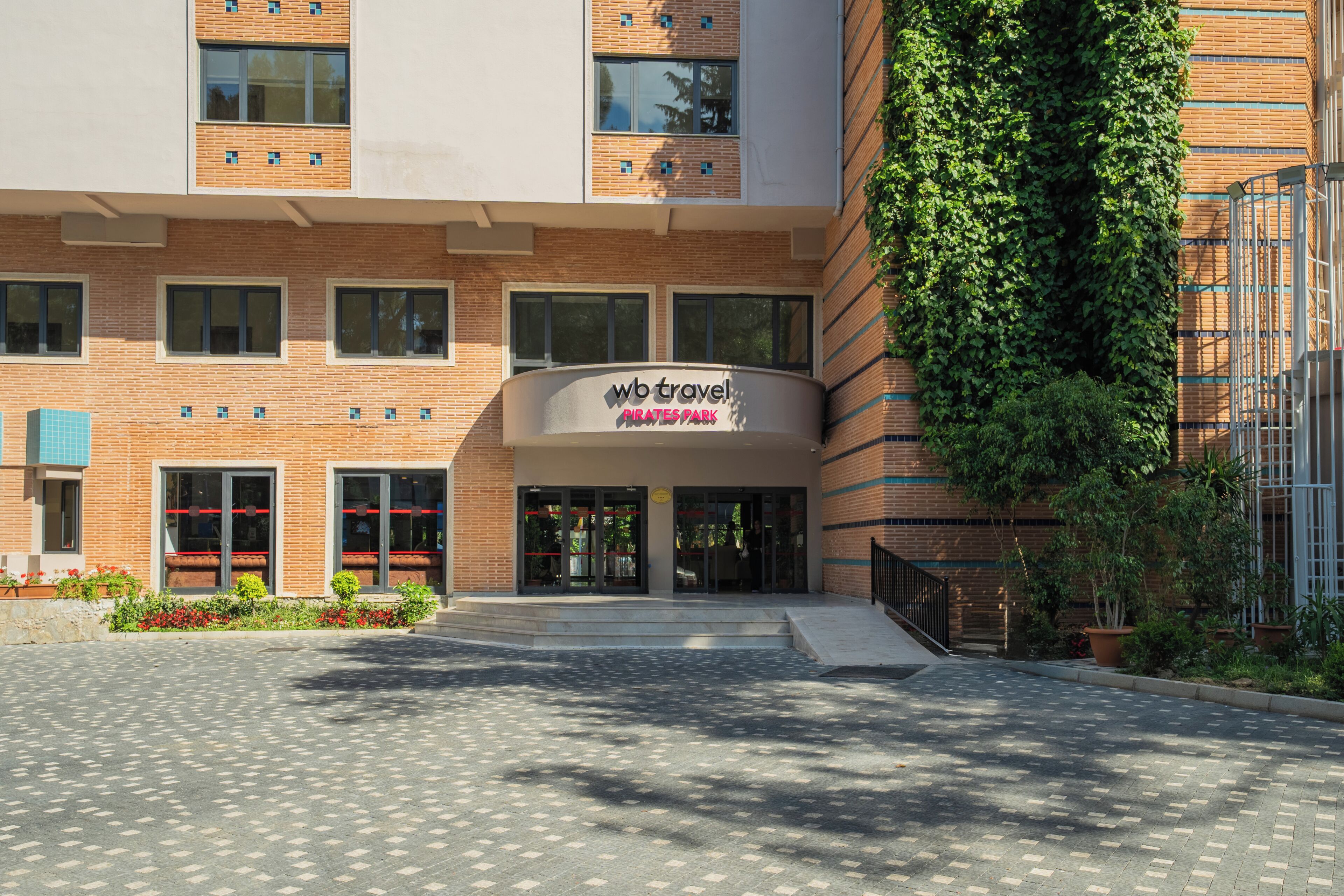 A modern building with a sign reading 'WB Travel Skatespark.'