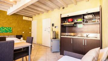 Mini-fridge, stovetop, cookware/dishes/utensils