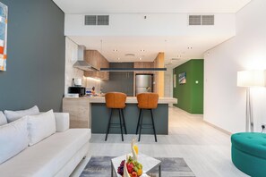 Deluxe Suite 3 Bedroom | Living area | 55-inch Smart TV with digital channels