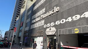 A building with a large sign for "Marina Pinnacle" and a contact number. - Samaya Holiday Homes - Marina luxury Suites (Dubai)