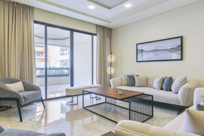 Una sala moderna con un sofá, un sillón y una mesa de centro.
